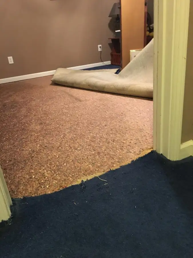 Carpet pad removal revealing water damage during Drying & Dehumidification in Gardiner